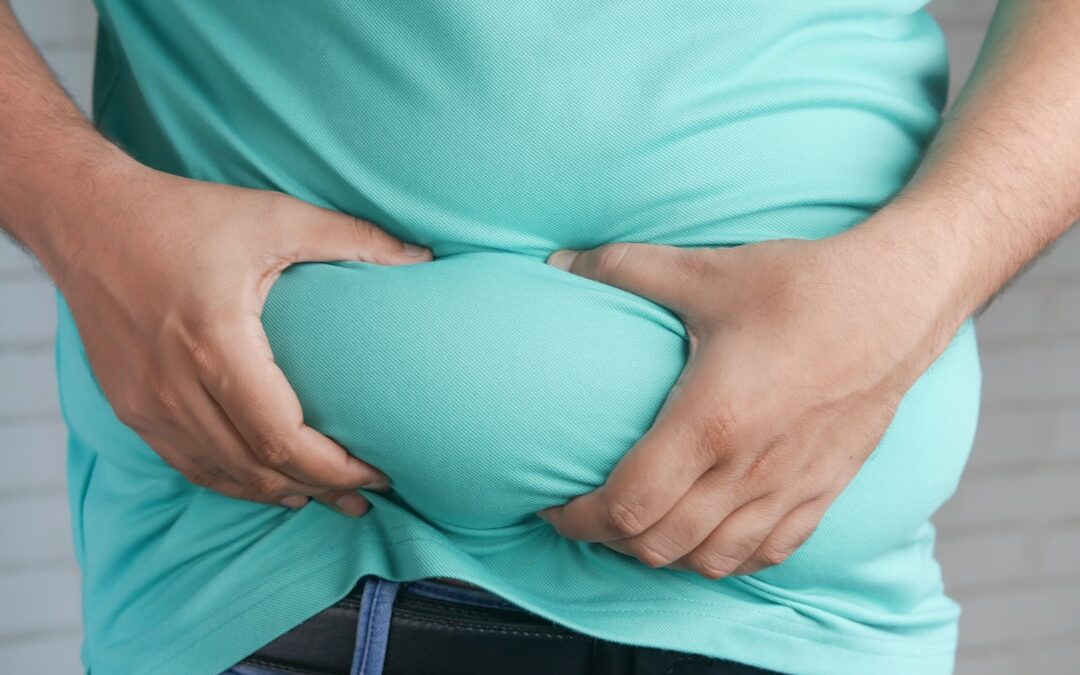 a woman holding her stomach with his hands