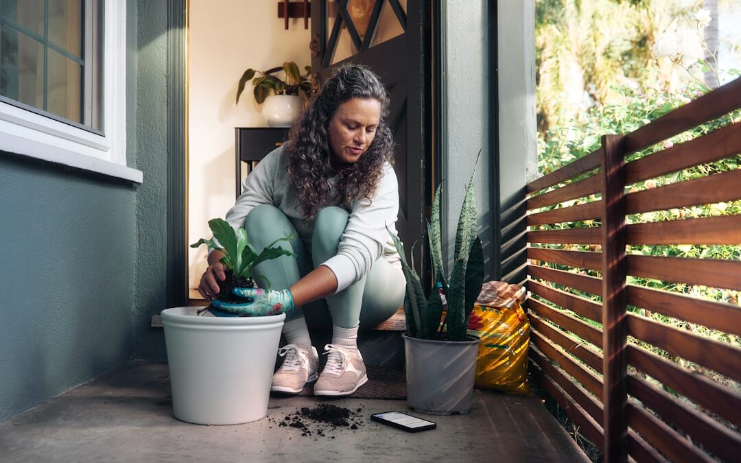A woman repotting a houseplant at home, representing nurturing your hormonal health naturally
